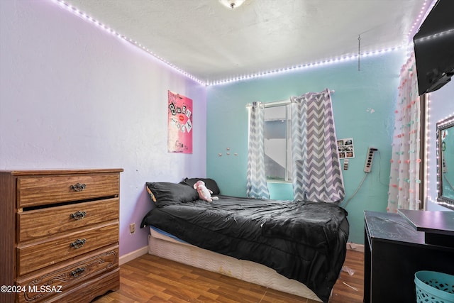 bedroom with hardwood / wood-style floors