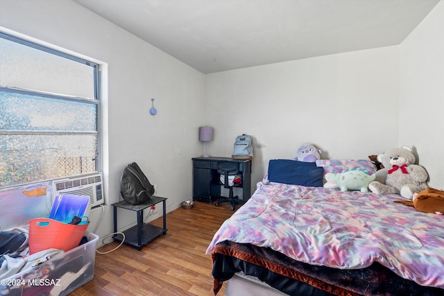 bedroom with hardwood / wood-style floors