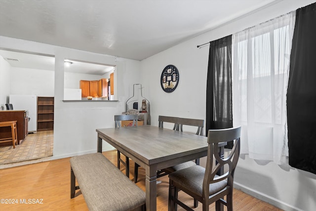 dining space with light hardwood / wood-style flooring