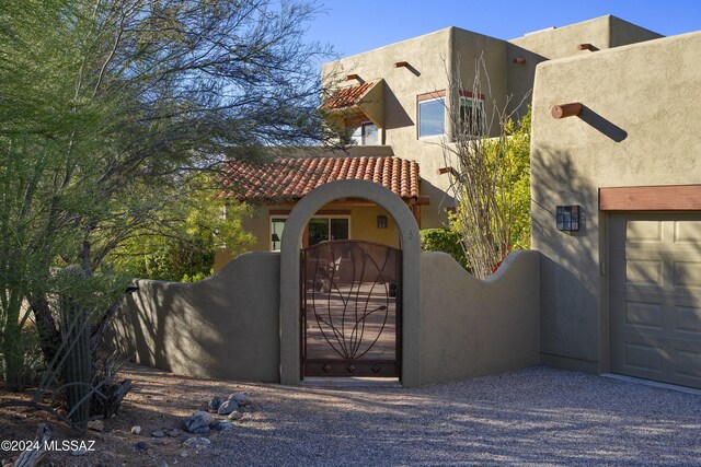 pueblo-style home with a garage