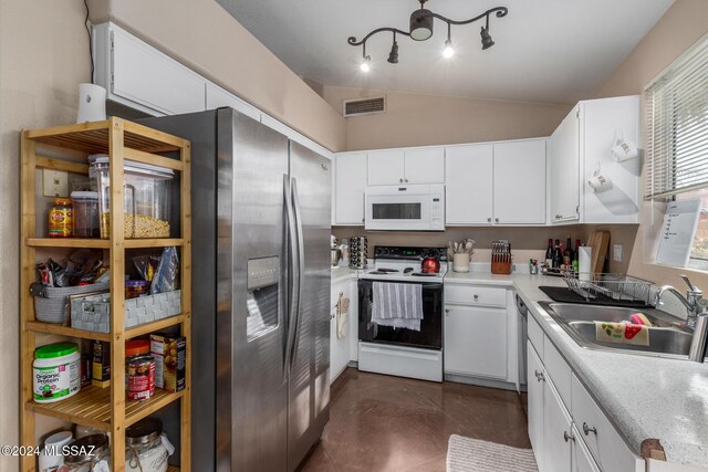 kitchen with white cabinetry, white appliances, sink, and vaulted ceiling