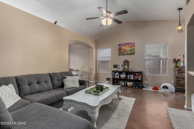 tiled living room with ceiling fan and lofted ceiling