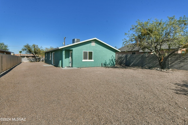 rear view of property featuring central AC