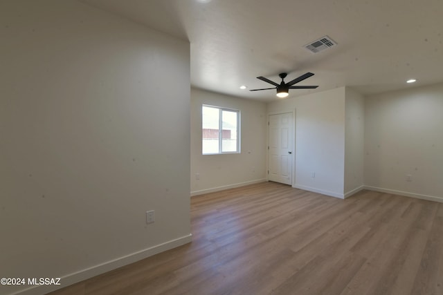 empty room featuring ceiling fan and light hardwood / wood-style floors