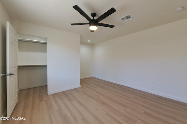 unfurnished bedroom with ceiling fan, a closet, and light hardwood / wood-style floors