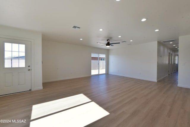 interior space with ceiling fan, plenty of natural light, and light wood-type flooring