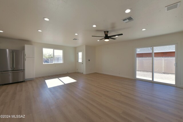 unfurnished living room with light hardwood / wood-style floors and ceiling fan