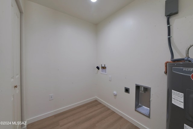 laundry area with hookup for a washing machine, light hardwood / wood-style floors, electric dryer hookup, and water heater