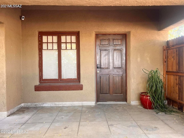 view of home's exterior with fence and stucco siding