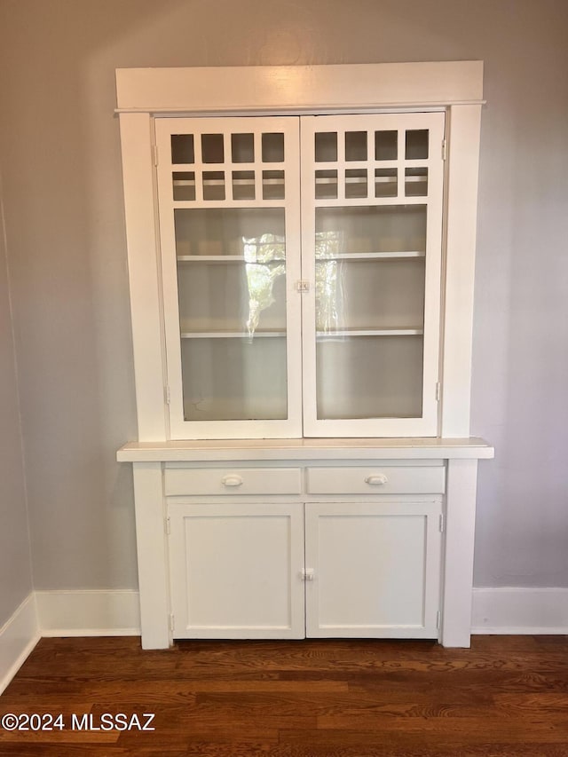 room details with baseboards and wood finished floors