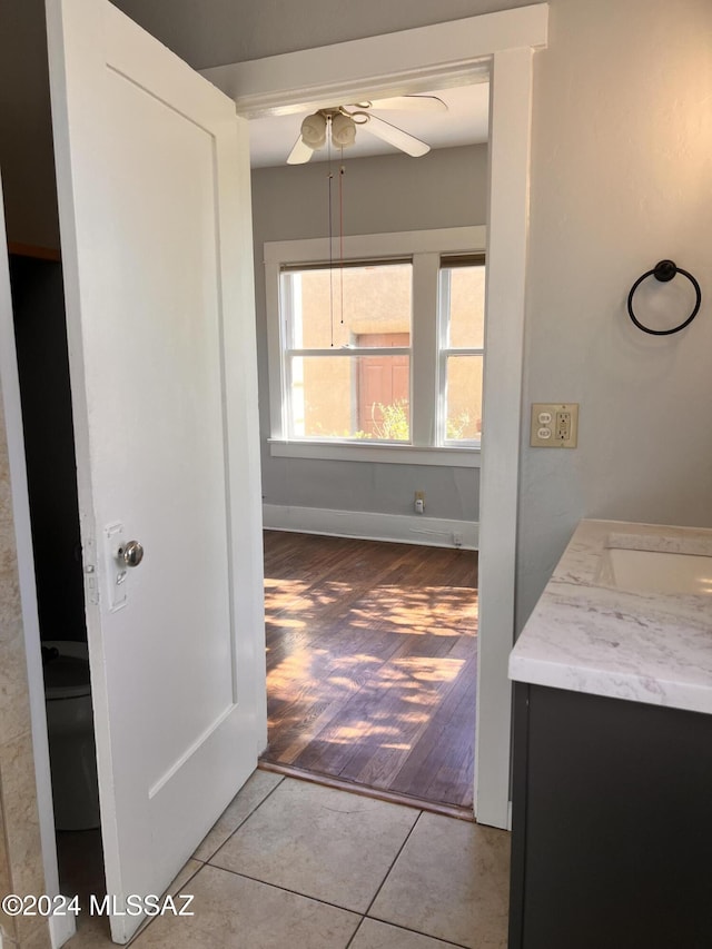 bathroom featuring vanity, tile patterned flooring, a ceiling fan, and baseboards