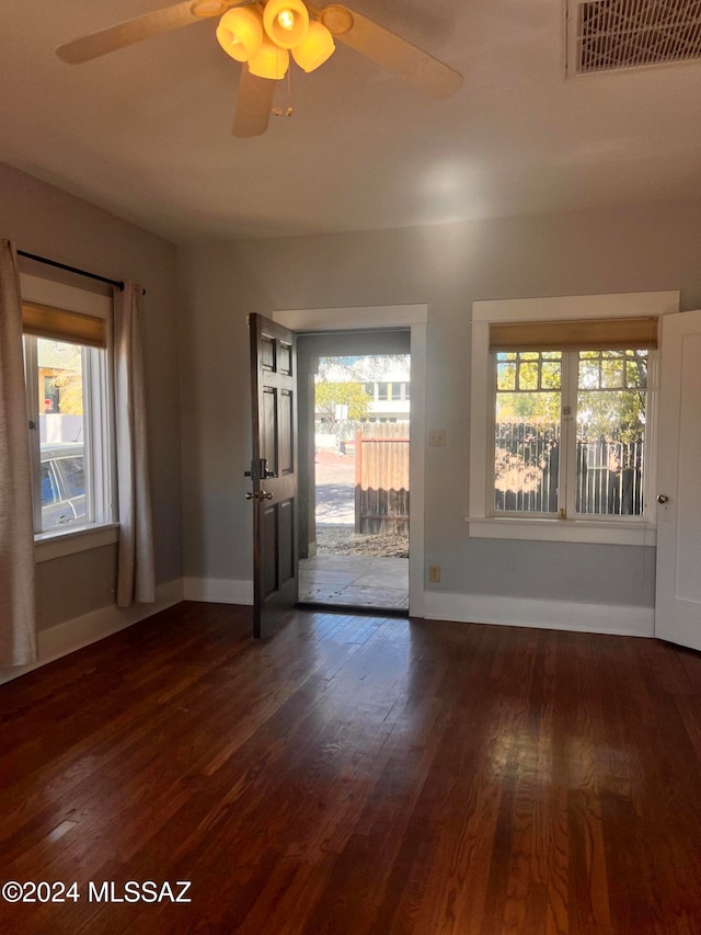 unfurnished room featuring dark hardwood / wood-style floors and ceiling fan