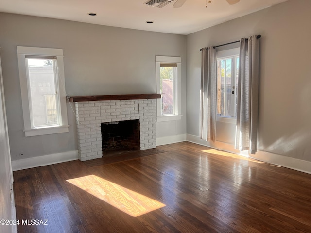 unfurnished living room with baseboards, a fireplace, visible vents, and wood finished floors