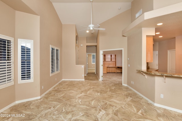 spare room with high vaulted ceiling and ceiling fan