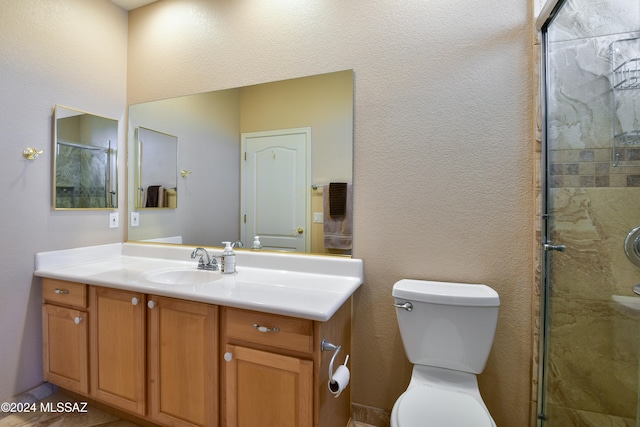 bathroom with vanity, toilet, and walk in shower