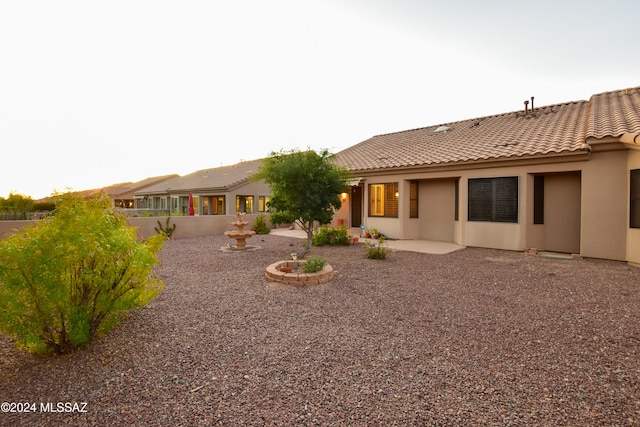 back of property with a patio