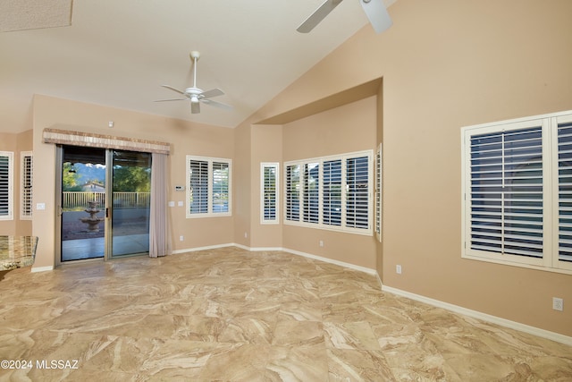 unfurnished room with high vaulted ceiling and ceiling fan