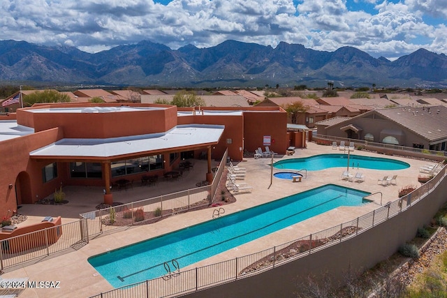 view of swimming pool featuring a mountain view and a patio