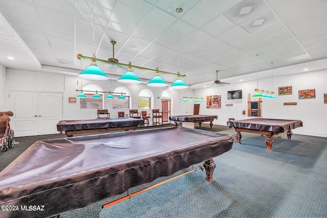 recreation room with ceiling fan, a drop ceiling, dark carpet, and pool table