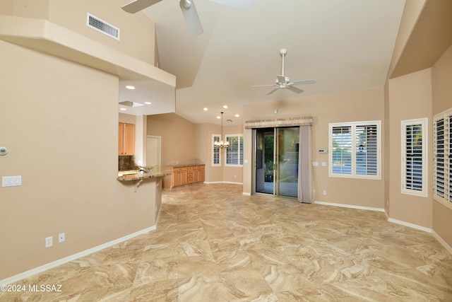 interior space with lofted ceiling and ceiling fan with notable chandelier