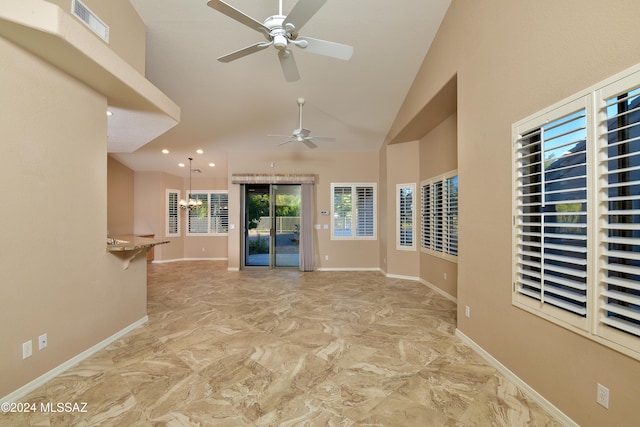 interior space with ceiling fan with notable chandelier and vaulted ceiling