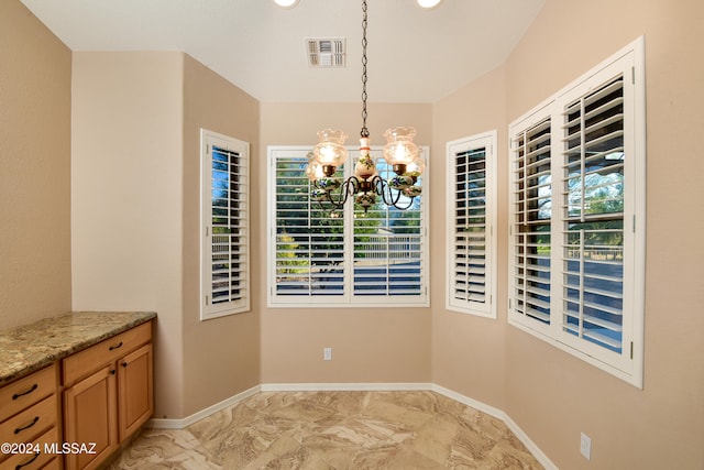 unfurnished dining area featuring an inviting chandelier