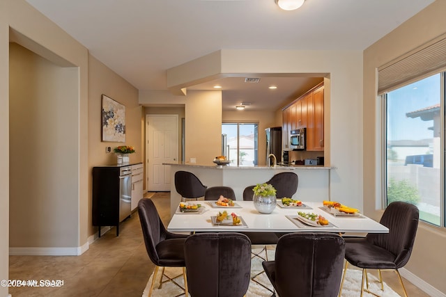 dining space featuring visible vents, baseboards, and light tile patterned flooring