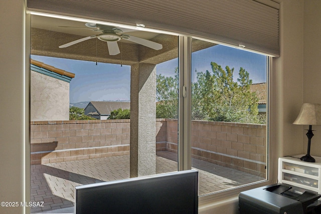 doorway featuring ceiling fan