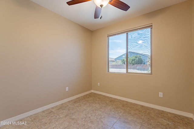 unfurnished room with ceiling fan and baseboards