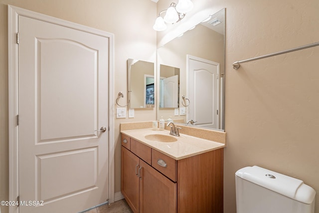 half bath featuring toilet and vanity