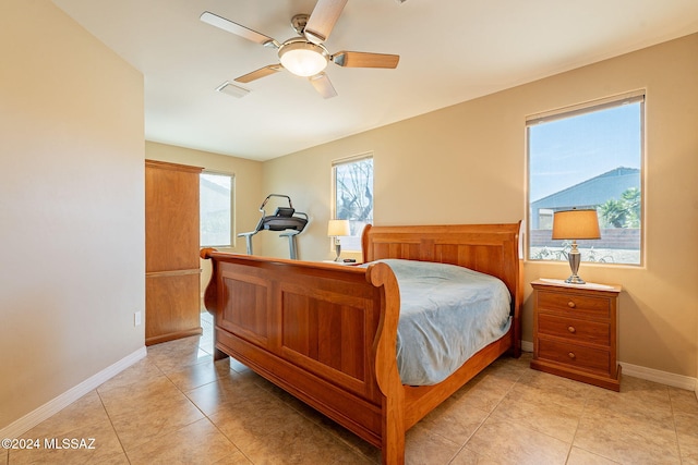 bedroom featuring light tile patterned floors, a ceiling fan, visible vents, and baseboards