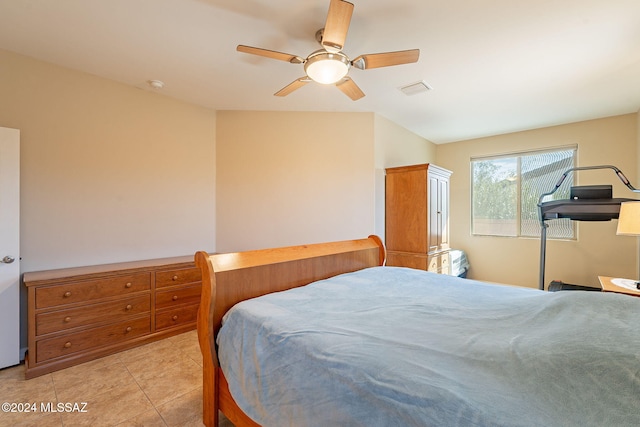 bedroom with ceiling fan, visible vents, and light tile patterned flooring