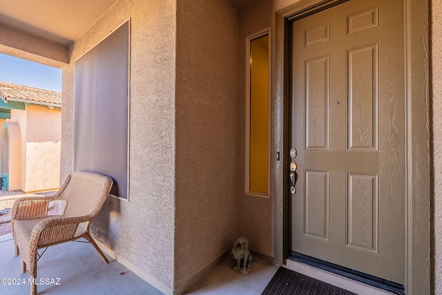 view of exterior entry with stucco siding