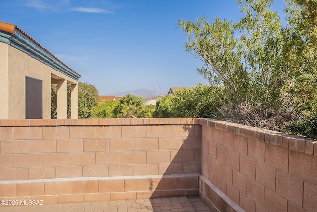 exterior space featuring stucco siding and fence
