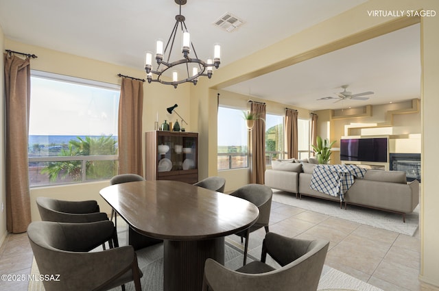 4594 S Moon River Pl, Green Valley, AZ 85622 - dining room featuring a chandelier, healthy amount of natural light, light tile patterned flooring, and a ceiling fan