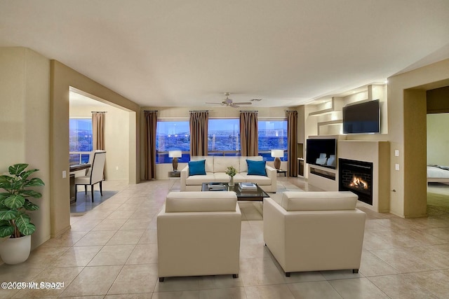 living room featuring ceiling fan and light tile patterned flooring