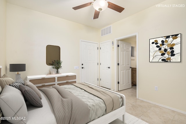 4594 S Moon River Pl, Green Valley, AZ 85622 - bedroom featuring ensuite bathroom, ceiling fan, and light tile patterned floors