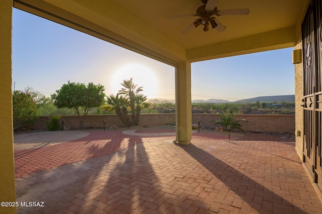 4594 S Moon River Pl, Green Valley, AZ 85622 - patio terrace at dusk with a patio, ceiling fan, and a fenced backyard