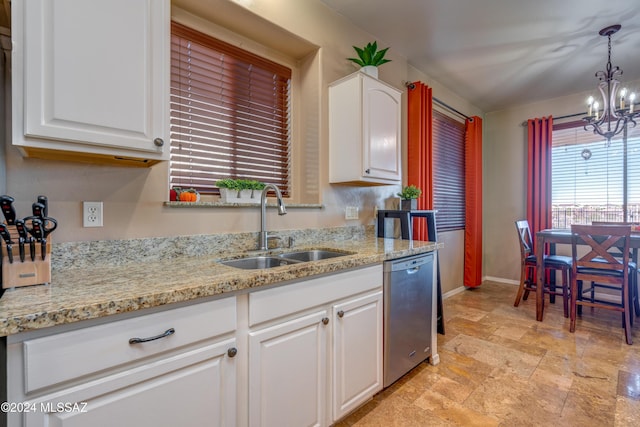 kitchen with baseboards, white cabinets, decorative light fixtures, stainless steel dishwasher, and a sink