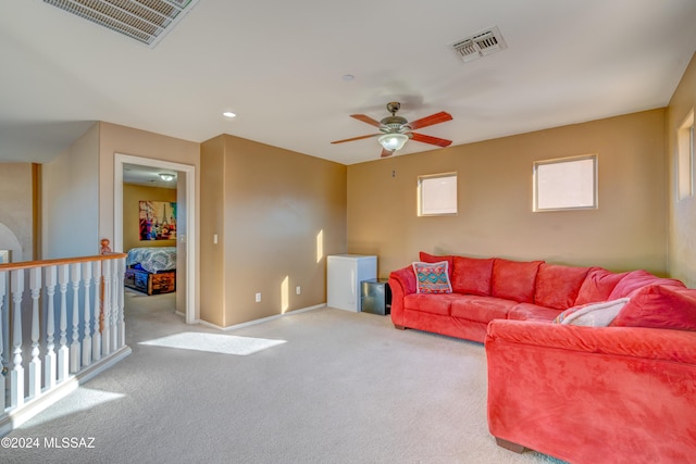 living area with carpet, visible vents, baseboards, and recessed lighting