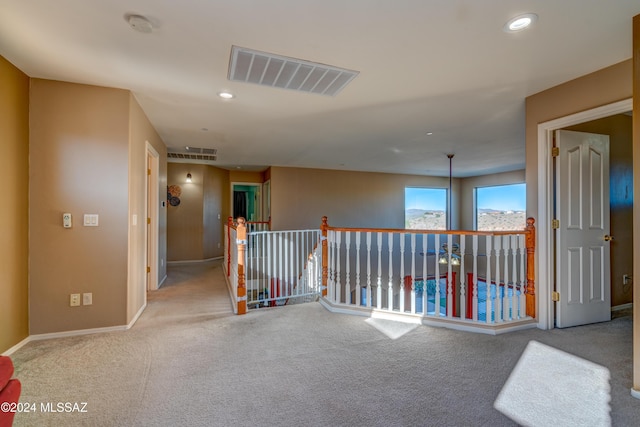 hallway featuring recessed lighting, visible vents, carpet flooring, an upstairs landing, and baseboards