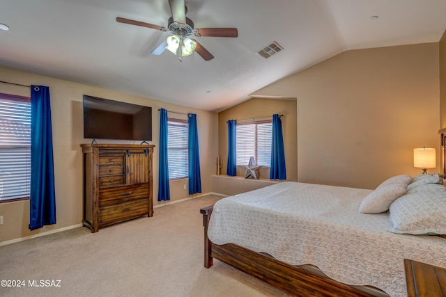 bedroom featuring lofted ceiling, baseboards, visible vents, and light colored carpet