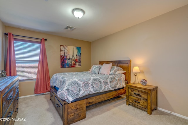 bedroom featuring light colored carpet, visible vents, and baseboards