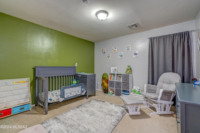 bedroom with a nursery area, carpet flooring, visible vents, and baseboards