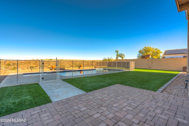 view of yard featuring a fenced in pool, a patio area, and a fenced backyard