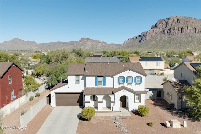 view of front facade featuring a mountain view and a garage