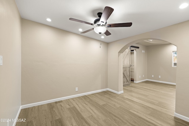 empty room featuring ceiling fan and light wood-type flooring