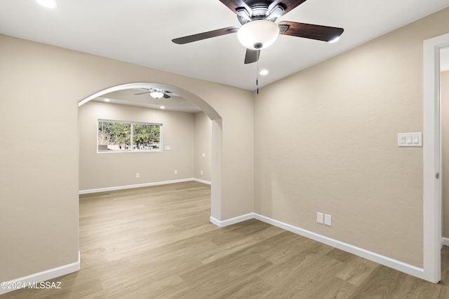 spare room featuring light wood-type flooring and ceiling fan