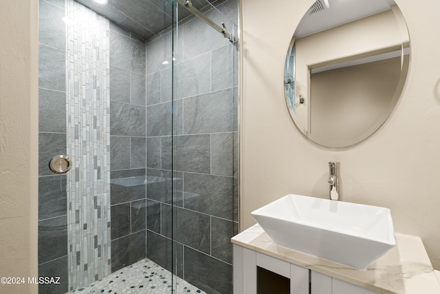 bathroom with vanity and a shower with shower door