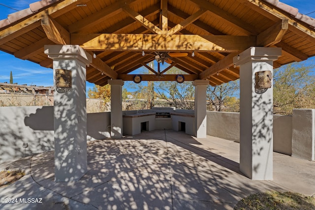 view of patio / terrace featuring a gazebo, ceiling fan, and exterior kitchen